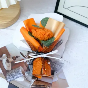 Handmade knitted flower bouquet with orange roses and stars mesh wrapping on stone base