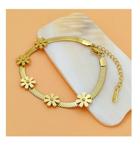 Detailed macro view of gold-plated daisy charms on flat blade chain with S.STEEL hallmark
