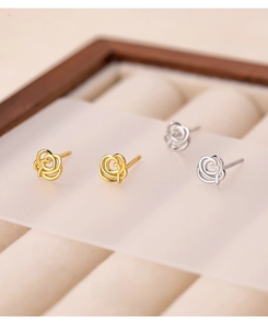 Detailed view of hollow rose stud earrings in gold and silver S999 sterling silver