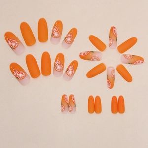 Oval matte orange press-on nails set with elegant orange fruit slice patterns
