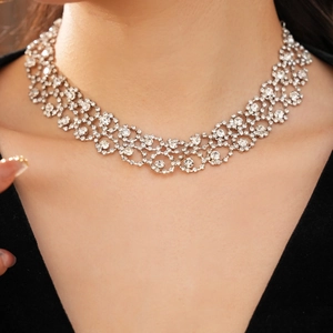 Close-up of sparkling rhinestone necklace with circular fringe on a model's neck