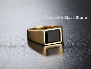 Macro view of gold-plated stainless steel signet ring with a polished black rectangular stone