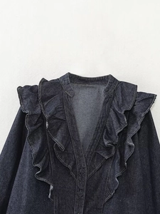 Detail of dark blue denim blouse showing the ruffled V-neckline and tiered collar