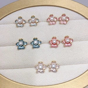 Detail of five flower stud earrings with freshwater pearls and zircon accents