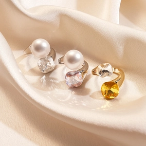 Three irregular open rings with faux pearls and crystals on soft silk background