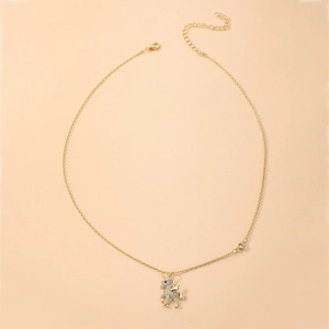 Detailed view of a gold unicorn pendant necklace with sparkling crystal embellishments