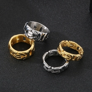 Close-up of gold and silver hollow V-shaped king chain rings in stainless steel