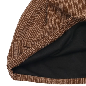 Close-up of brown ribbed knit beanie with soft black lining for double warmth
