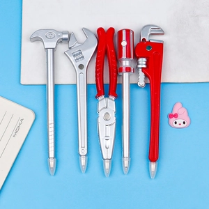 Set of creative hardware tool ballpoint pens in hammer and wrench shapes on blue background