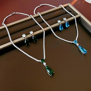 Detail of water drop zircon jewelry sets with green and blue gems and silver chains