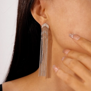 Silver metallic tassel earrings with geometric arrows worn by model for high-end look
