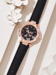 Close-up of black leather watch with butterfly dial and rose gold rhinestone bezel