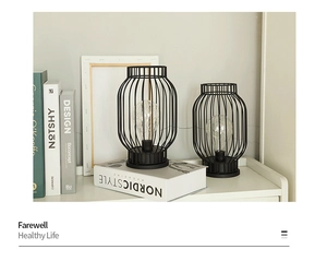 Black metal lantern decor set with LED filament on white shelf in Nordic style