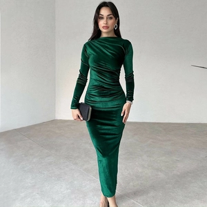 Detail of dark green velvet dress featuring elegant slimming ruched pleats and texture
