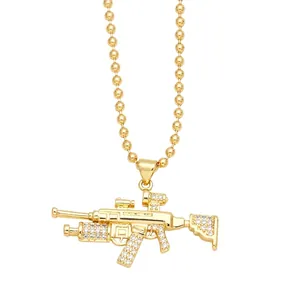 Iced out gold machine gun pendant necklace with rhinestone accents and ball chain