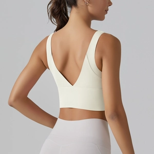 Detail view of cream V-back sports bra showing breathable fabric and supportive back design