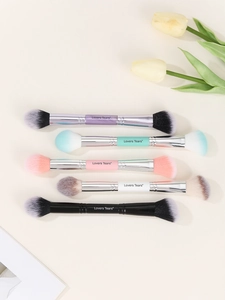 Detailed flat lay of five double-ended makeup brushes in various pastel handle colors