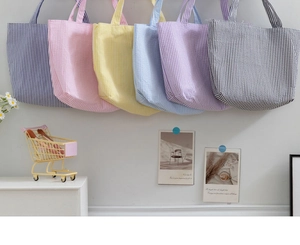Detailed collection of striped tote bags in multiple colors with seersucker texture