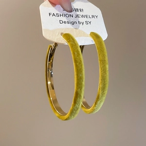 Close-up of yellow-green flocked hoop earrings with gold inner band and S925 silver posts