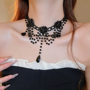 Close-up of black beaded choker necklace with gothic floral crystal tassels
