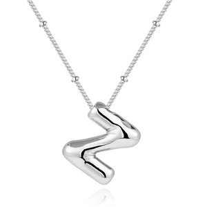 Macro shot of silver bubble letter Z pendant on a bead chain necklace with reflections