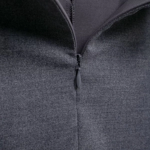 Macro detail of high-quality invisible zipper on dark grey pleated mini skirt