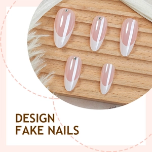 French almond press-on nails with pink base, white tips and sparkling diamond accents