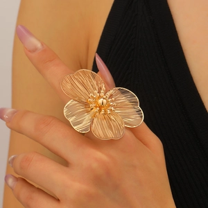 Macro detail of French style gold flower ring with brushed texture on petals