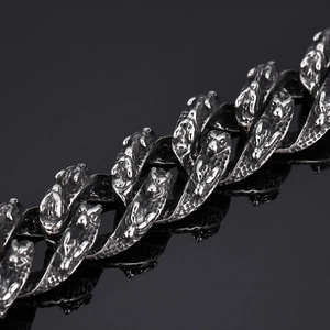 Detail of retro silver-black stainless steel chain with intricate dragon scale texture