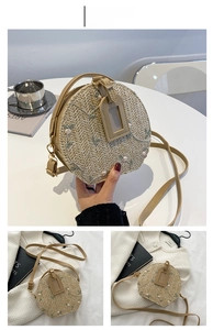 Detail of round khaki straw crossbody bag with floral embroidery and ring handle