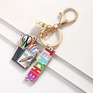 Close-up of Back to School teacher keychain with white pearl and stationery pendants