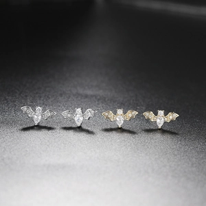 Fashionable gold and silver bat stud earrings with sparkling cubic zirconia stones