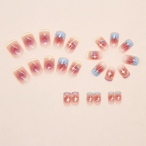Macro detail of pink gradient press-on nails with heart, star, and fluid drip patterns