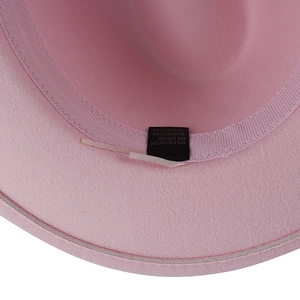 Macro shot of pink wool fedora interior showing 65% cotton blend label and sweatband