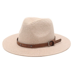 Detail of beige straw hat with dark brown leather band and metal rivet buckle