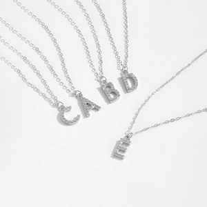 S925 sterling silver alphabet pendant necklace with zircon inlay on white background