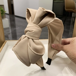 Elegant beige fabric layered bow headband with stylish wide band and black anti-slip edge