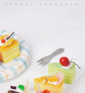 Close-up of artificial fruit mousse cakes with realistic textures on a plaid plate