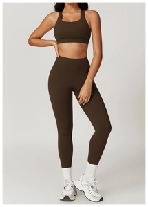 Detailed view of high-waisted chocolate yoga pants and matching matte sports vest set
