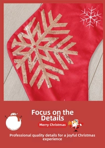 Close-up of golden sequin snowflake and white embroidery on a red satin Christmas stocking