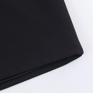 Nahaufnahme der schwarzen Stofftextur und der sauberen Nähte dieses modischen Minikleids