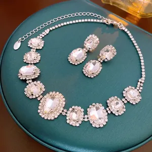 French style oval crystal necklace and earrings set on green velvet luxury jewelry box