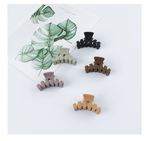 Detail showing five matte hair claws in black, grey, brown, purple and khaki tones