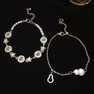 Detail of vintage flower bracelet with green cat-eye stone and silver zircon inlay