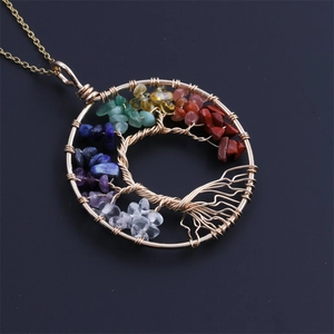 Macro shot of tree of life pendant with colorful chakra stones and gold wire wrapping