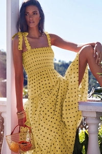 Detail of yellow floral maxi dress with bow shoulder straps and ruched bust design