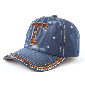 Denim baseball cap with rhinestone T letter and silver studs on navy blue washed fabric