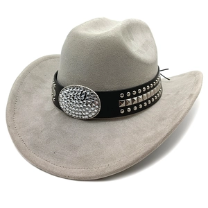 Detail of grey suede cowboy hat with rhinestones and metal studs on leather band