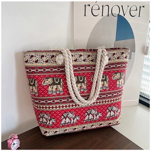 Detailed close-up of a red ethnic canvas tote bag with elephant pattern and rope handle