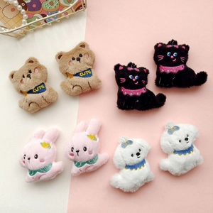 Detailed view of eight plush animal brooches featuring bear, cat, rabbit, and dog designs